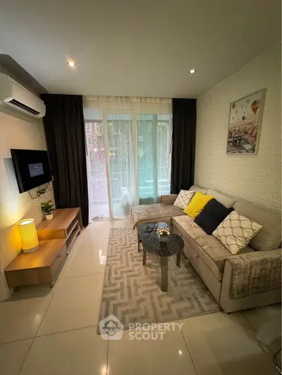 Cozy living room with modern decor, featuring a comfortable sofa, stylish coffee table, and wall-mounted TV.