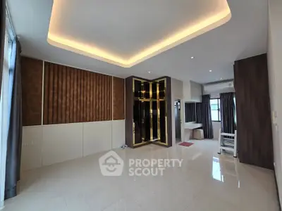 Spacious modern living room with elegant ceiling lights and large windows
