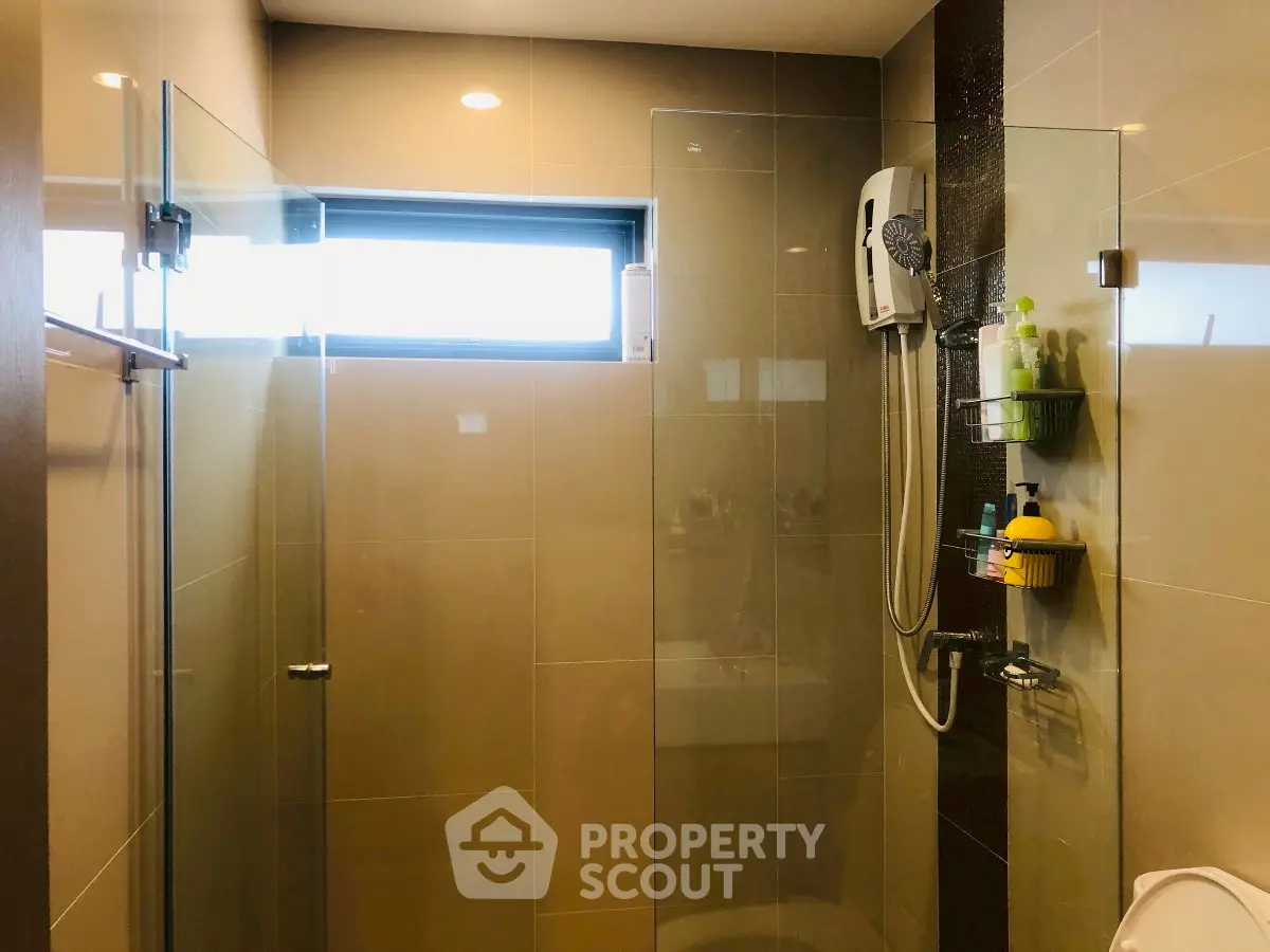 Modern bathroom with glass shower enclosure and sleek fixtures