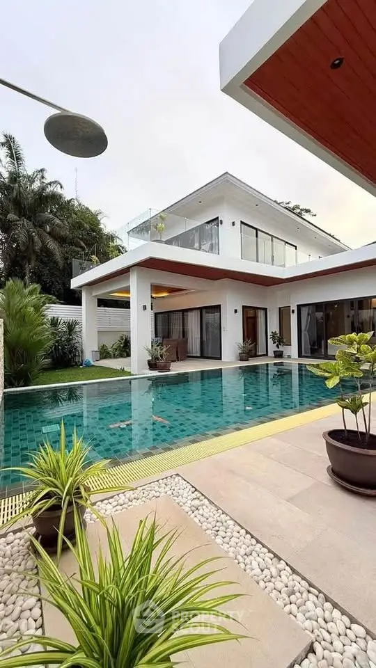 Luxurious modern villa with private pool and lush garden, perfect for serene living.