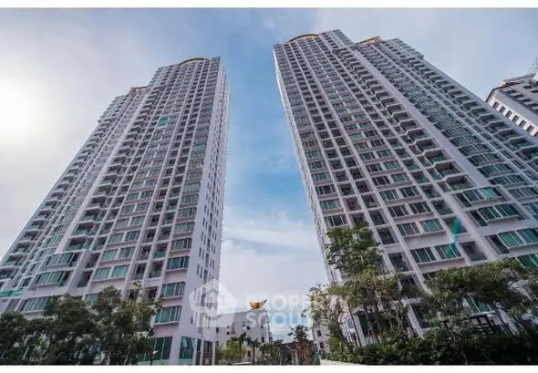 Stunning high-rise residential towers with modern architecture and lush greenery.