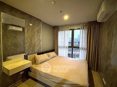 Modern bedroom with city view, featuring elegant decor and natural light through large window.