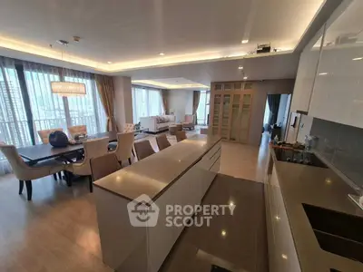 Luxurious open-plan living and dining area with modern kitchen in high-rise apartment