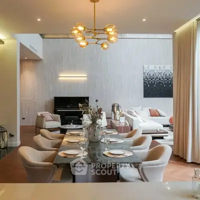 Luxurious open-plan living and dining area with elegant decor and modern lighting.