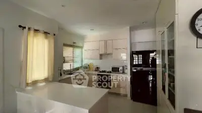 Modern kitchen with sleek cabinetry and gas stove in a bright, airy space.