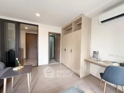 Modern living room with sleek furniture and built-in storage, featuring a minimalist design.