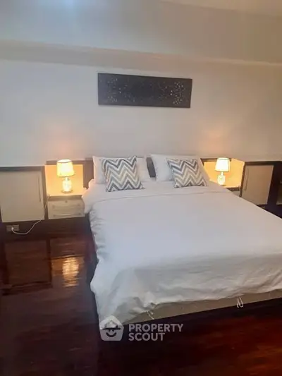 Elegant bedroom with cozy lighting and stylish decor, perfect for relaxation and comfort.
