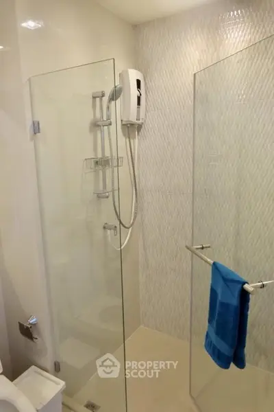 Modern bathroom with glass shower enclosure and sleek fixtures