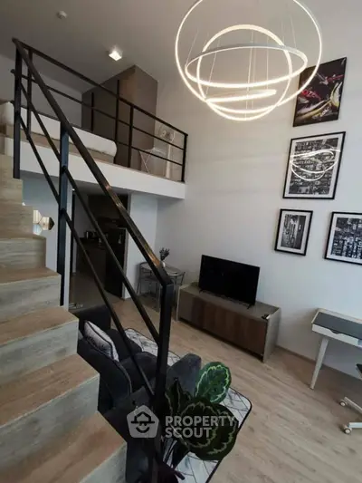 Modern loft-style living room with stylish staircase and unique lighting