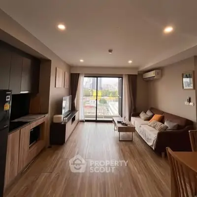 Spacious modern living room with city view, wooden flooring, and cozy furnishings.