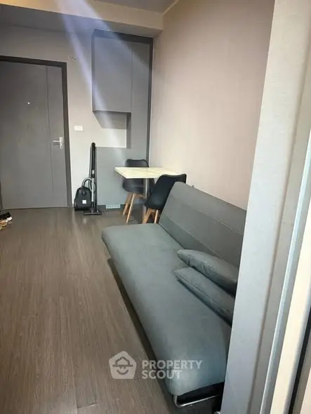 Modern living room with sleek sofa and compact dining area