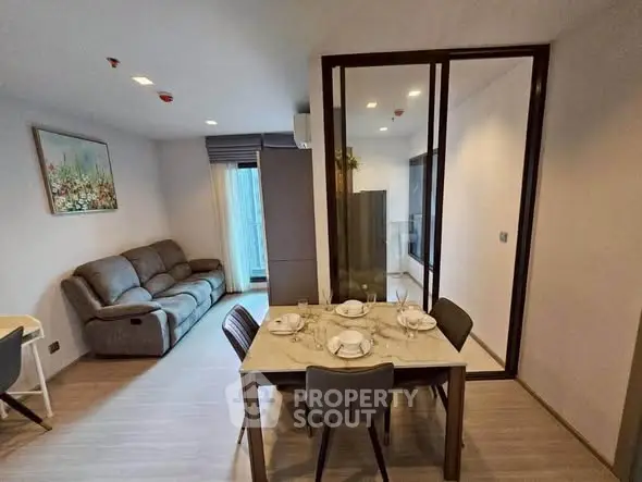 Modern open-plan living and dining area with stylish furniture and natural light.