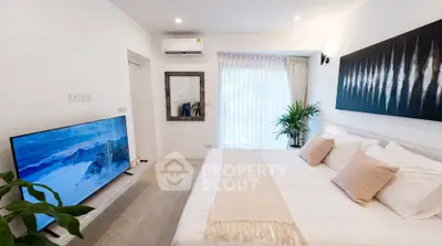 Modern bedroom with large TV and stylish decor