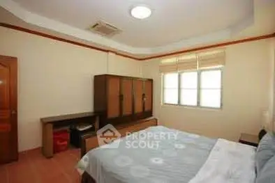 Spacious bedroom with ample natural light and modern furnishings