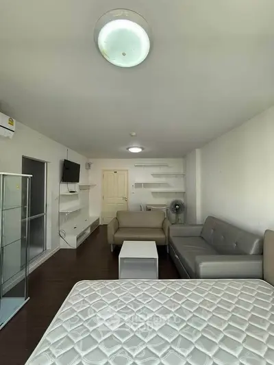 Spacious living room with modern furniture and natural light, perfect for relaxation and entertainment.