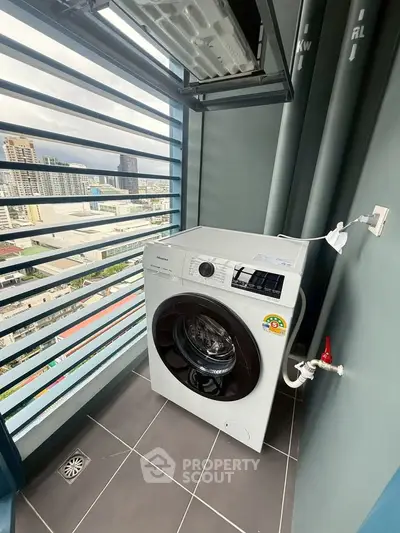 Modern balcony with washing machine and city view, perfect for urban living convenience.