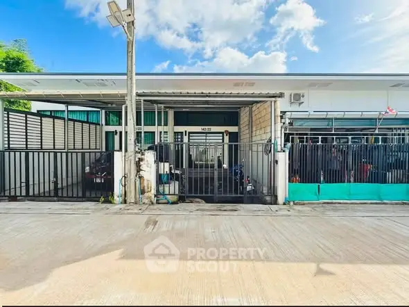 Charming single-story home with gated entrance and modern facade, perfect for family living.