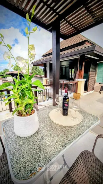 Luxurious balcony with elegant outdoor dining setup and scenic view