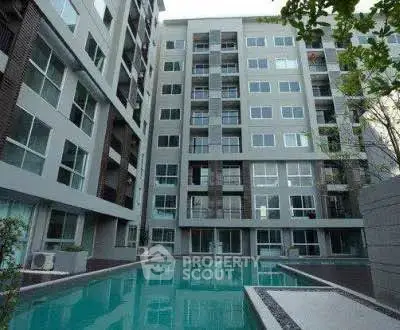 Modern apartment building with a luxurious pool area, perfect for urban living.