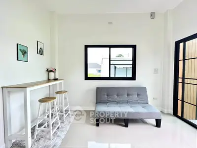 Modern living room with sleek furniture and natural light, perfect for cozy gatherings.