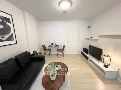 Modern living room with sleek black sofa and stylish decor