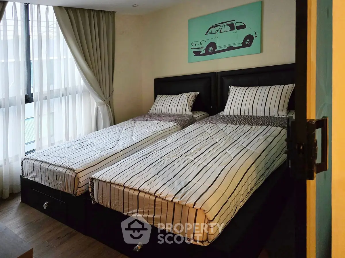 Cozy bedroom with twin beds and stylish decor in modern apartment