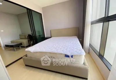 Modern bedroom with large windows and stylish furniture in a bright apartment.