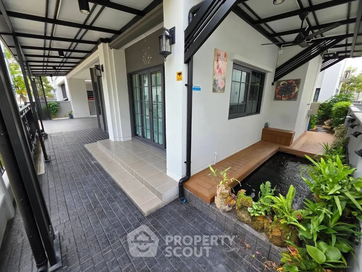 Modern home exterior with stylish walkway and serene water feature