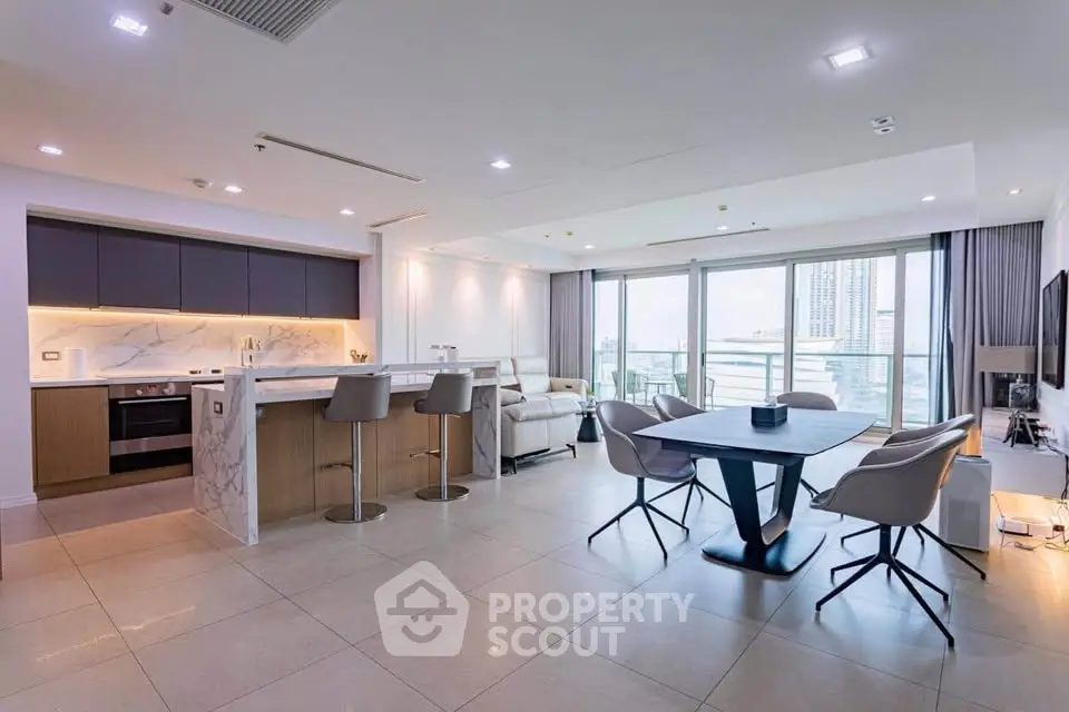 Spacious modern living room with open kitchen and city view balcony