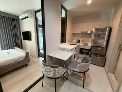 Modern studio apartment with compact kitchen and cozy bedroom