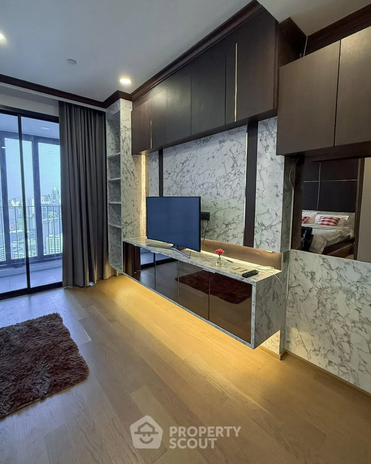Luxurious living room with marble accents and balcony view in modern apartment