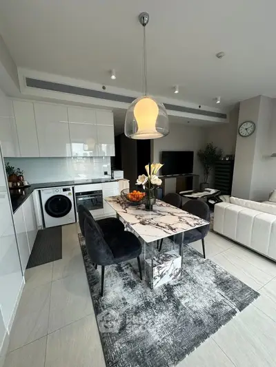 Modern open-plan kitchen and living area with stylish decor and appliances.