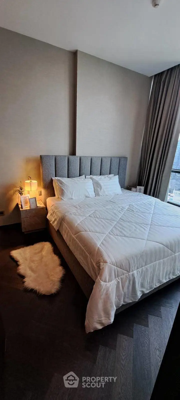 Luxurious bedroom with plush bed and cozy decor in modern apartment