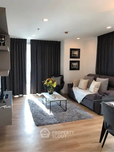 Modern living room with cozy sofa, stylish decor, and natural light.