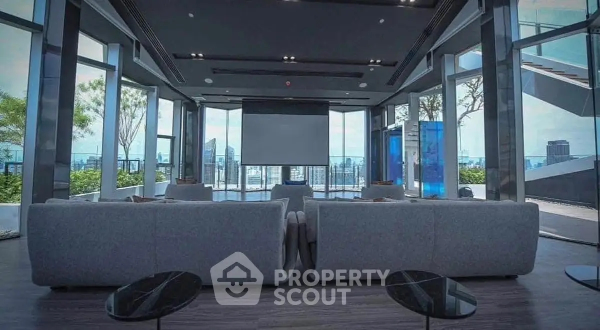 Luxurious modern living room with panoramic city views and sleek furnishings.