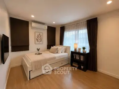 Cozy bedroom with modern decor, featuring a comfortable bed, wooden flooring, and ambient lighting.
