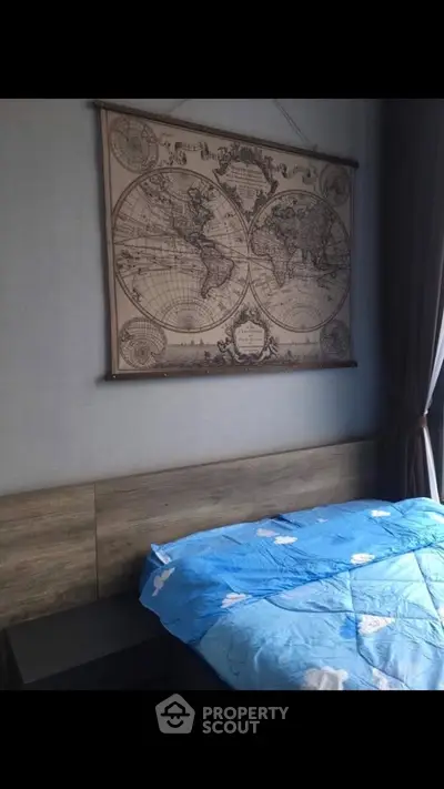 Cozy bedroom with vintage world map decor and blue bedding