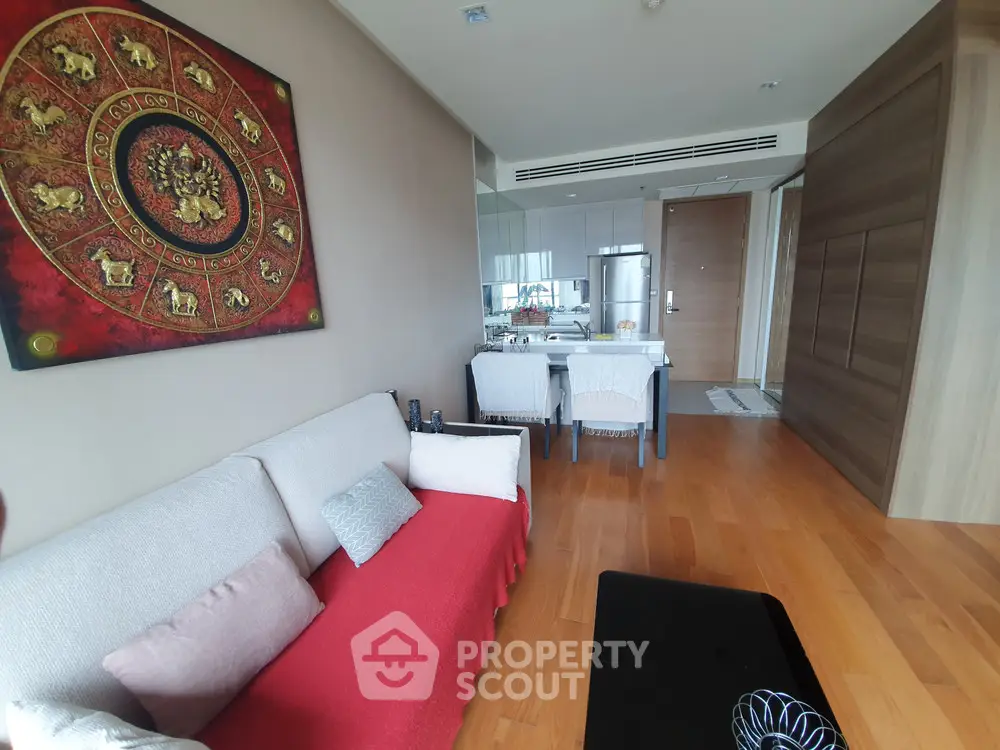 Modern living room with wooden flooring and stylish decor in a contemporary apartment.