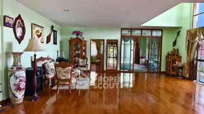 Spacious living room with elegant wooden flooring and classic decor