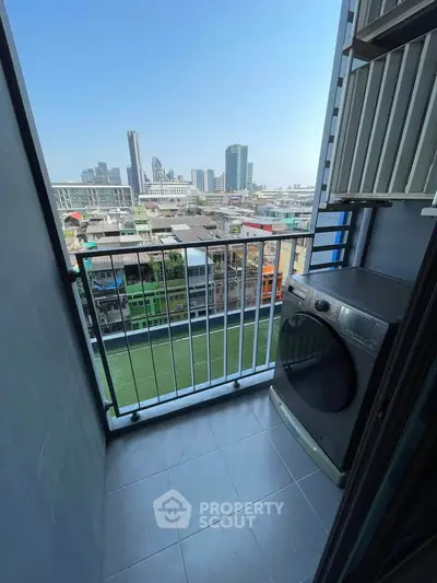 Charming balcony with city view and modern washing machine, perfect for urban living.