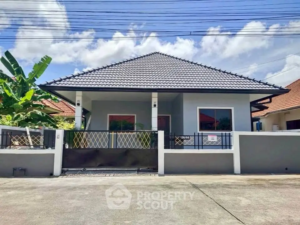 Charming single-story house with modern roof and fenced yard in a serene neighborhood.