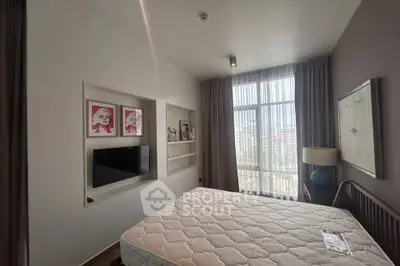 Modern bedroom with large window and built-in TV, perfect for urban living.