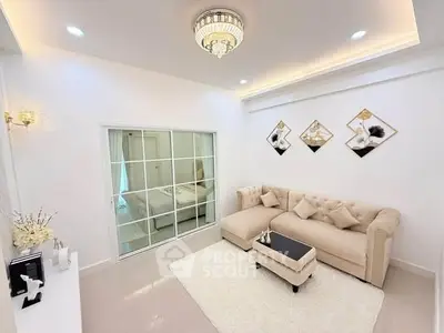 Elegant living room with plush sofa and modern decor in a stylish apartment.