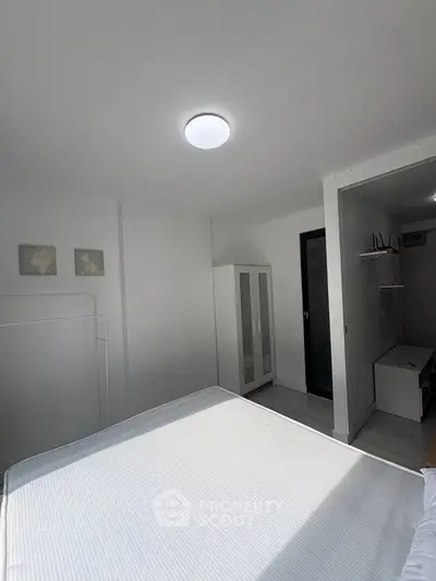 Bright minimalist bedroom with modern wardrobe and natural light