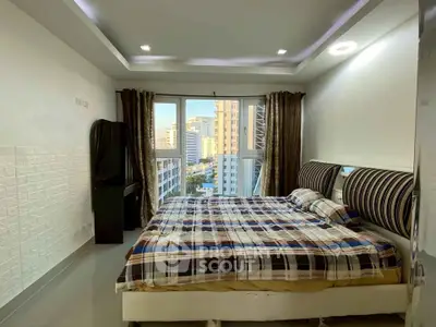 Spacious bedroom with city view and modern decor in high-rise apartment