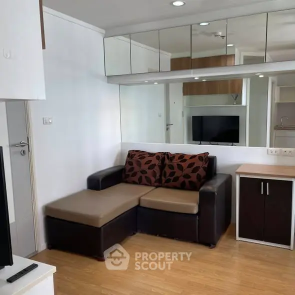 Modern living room with sleek furniture and mirrored wall design