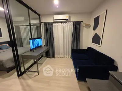 Modern studio apartment with glass partition, cozy living area, and stylish decor.