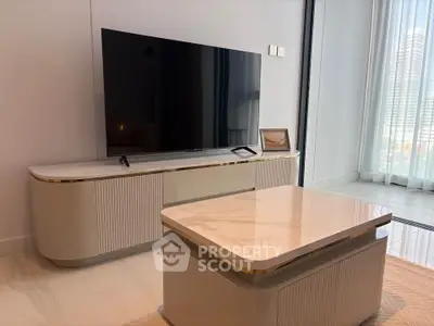 Modern living room with sleek TV stand and marble coffee table