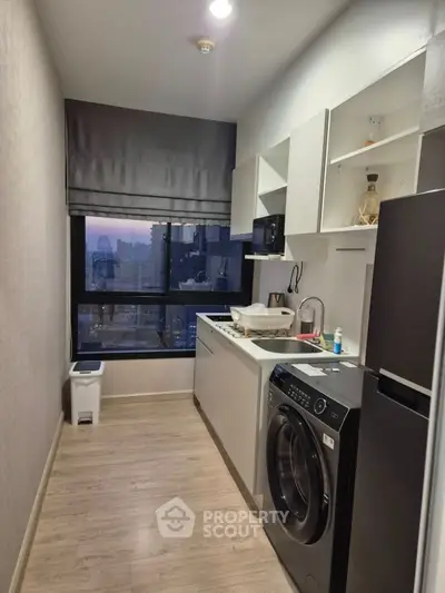 Modern compact kitchen with city view and washing machine