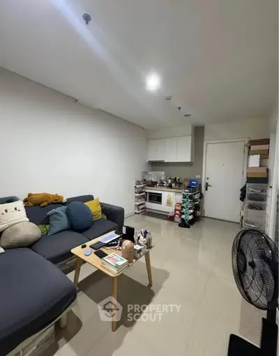 Cozy living room with modern decor and compact kitchen area